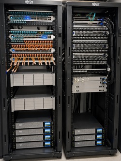 Business network racks with patch panels, switches, servers, and cabling during managed network support assessment